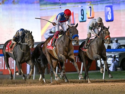 Country Grammer, ridden by Frankie Dettori and trained by Bob Baffert, wins the Dubai World Cup at Meydan racecourse on March 26, 2022.