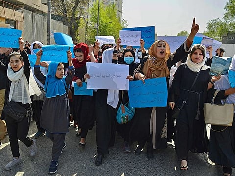 Afghan women and girls take part in a protest in front of the Ministry of Education in Kabul on March 26, 2022, demanding that high schools be reopened for girls.  