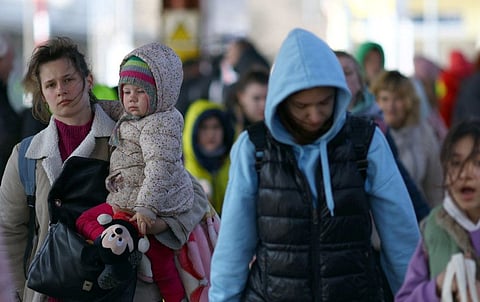 Ukrainian refugees board a train bound to Krakow, at Przemysl Glowny train station, in Poland on March 26, 2022. 