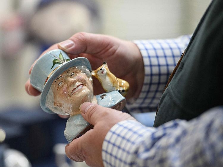 Proprietor of Goviers, Simon Willis inspects a Platinum Jubilee HM Queen Elizabeth II Character Jug