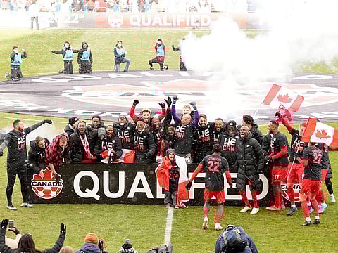 Canada players celebrate their win following a CONCACAF World Cup soccer qualifying match against Jamaica in Toronto, Sunday, March 27, 2022.