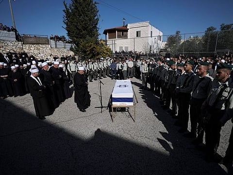 Mourners gather around the flag-draped coffin of Druze Israeli border police officer Yezen Falah, 19, during his funeral in the village of Kisra-Sumei, northern Israel, Monday, March 28, 2022. 