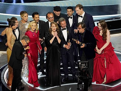 The cast and crew of "CODA" accept the award for best picture at the Oscars on Sunday, March 27, 2022, at the Dolby Theatre in Los Angeles. 