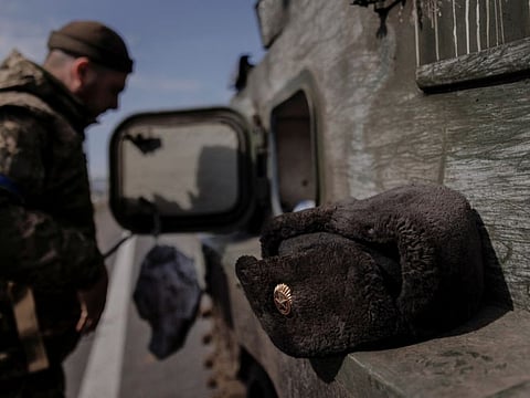 A Russian uniform hat rests on a Russian artillery vehicle that Ukraine captured during fighting outside Kharkiv as Russia's attacks on Ukraine continue, on March 29, 2022.   