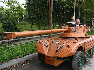 Photos: Vietnamese dad spends thousands converting van into wooden tank for son