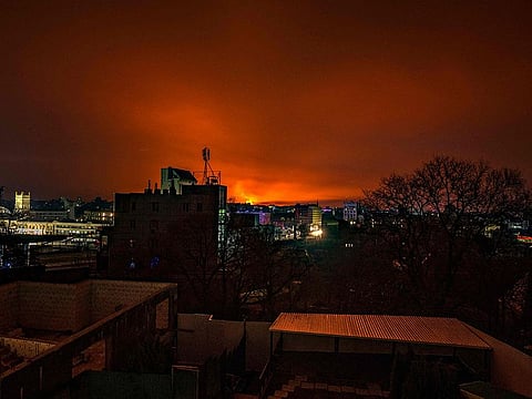 This general view taken on March 30, 2022 shows fire and smoke lighting up the night sky, east of Kharkiv. 