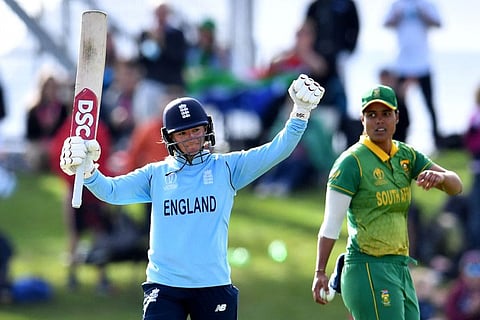 England's Danni Wyatt celebrates after reaching her century (100 runs) as South Africa Chloe Tryon (right) looks on during the 2022 Women's Cricket World Cup second semi-final match at Haley Oval in Christchurch.