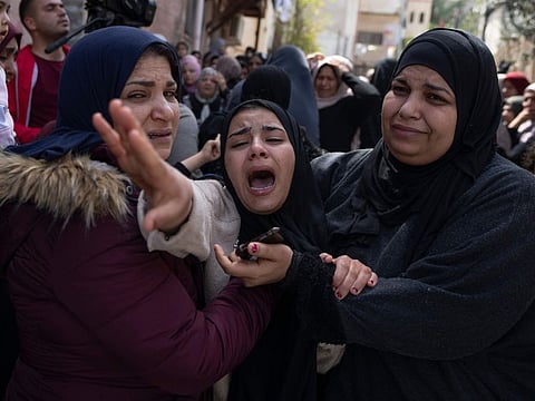 Palestinian Hadeel Abu Atiyeh, cries during the funeral of her brother Sanad Abu Atiyeh, 17, in the West Bank refugee camp of Jenin on March 31, 2022. 