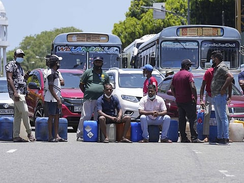 Sri Lankans block traffic as they protest demanding diesel near a gas station in Colombo on March 30, 2022.  