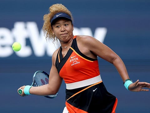 Naomi Osaka of Japan returns a shot to Belinda Bencic of Switzerland during the women's semifinals of the Miami Open at Hard Rock Stadium in Miami Gardens, Florida.