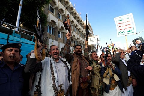 Armed men loyal to Yemen's Houthis chant slogans during a rally in Sana'a.