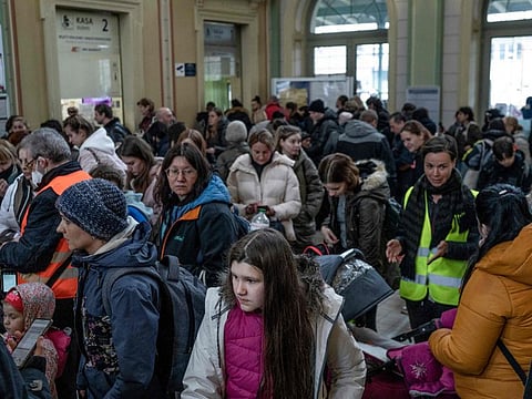 Refugees from Ukraine stand in line for free train tickets in the hall of the main railway station in Przemysl, southeastern Poland, near the Polish-Ukrainian border on April 1, 2022.