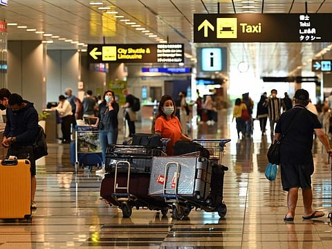 Travellers arrive at Changi International Airport in Singapore on April 1, 2022, as Singapore reopened its land and air borders to travellers fully vaccinated against the Covid-19 coronavirus.