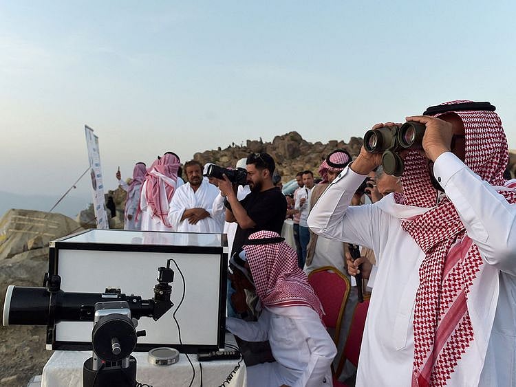Saudis look at the sky to spot the first crescent of the moon in the southwestern Saudi city of Taif on April 1, 2022.  