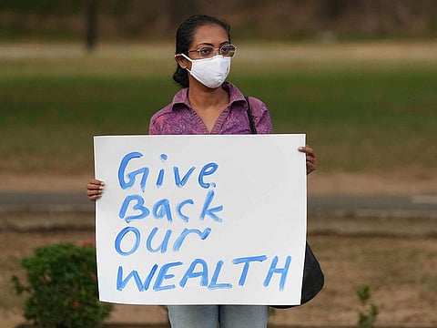 A Sri Lankan participates in a protest against the economic crisis, before the beginning of curfew in Colombo, on Saturday, April 2, 2022. 