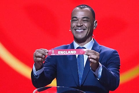 Former Brazilian footballer and World Cup winner Cafu displays the name of England during the draw for the 2022 World Cup in Qatar at the Doha Exhibition and Convention Center.