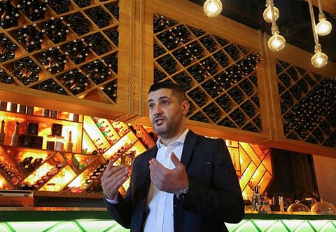 Lebanese restaurateur Akram Johari speaks during an interview at his restaurant in the Iraqi capital Baghdad.