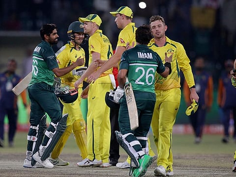 Pakistan's Babar Azam (left) and Imam-ul-Haq (centre) shake hands with Nathan Ellis and Ben McDermott after winning the third one day international cricket match at Gaddafi Stadium in Lahore, Pakistan. The two teams will meet tomorrow in a one-off T20 match in Lahore.