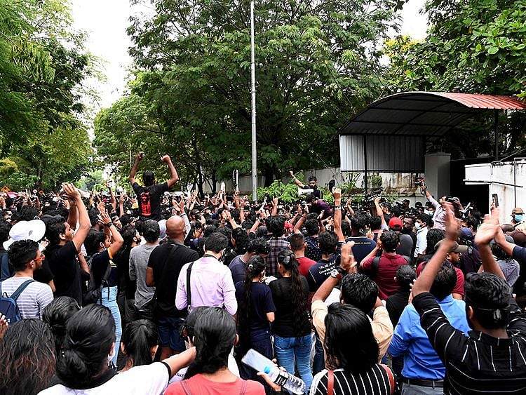 Demonstrators take part in a protest against the surge of prices and shortage of fuel and other essential commodities at the entrance of the Sri Lanka prime minister m]Mahinda Rajapaksa residence in Colombo on April 5, 2022.  