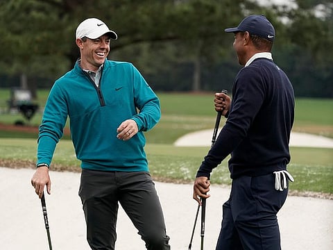 Tiger Woods (right) is greeted by Rory McIlroy during a practice round for the Masters at the Augusta National course on Tuesday.