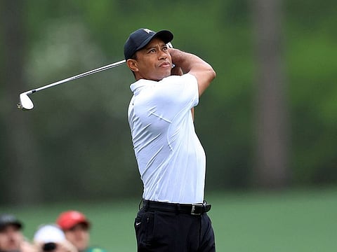 Tiger Woods of the United States plays his shot from the 12th tee during a practice round prior to the Masters at Augusta National Golf Club on April 06, 2022 in Georgia, US.   