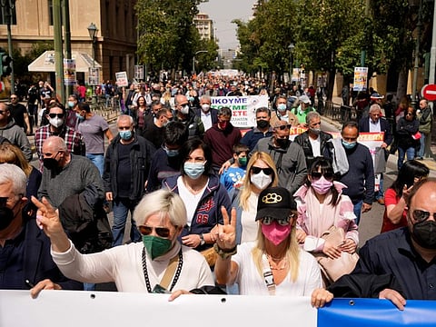 Demonstrators march during a 24-hour nationwide strike in Athens, Greece, Wednesday, April 6, 2022.