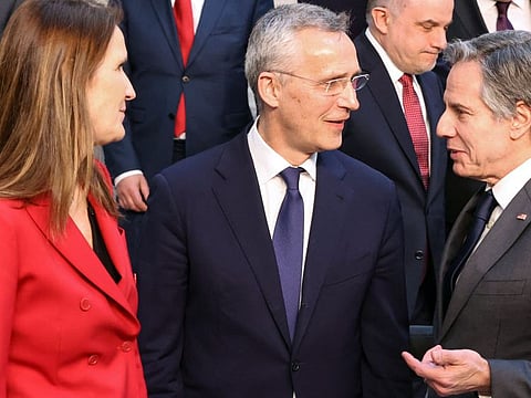From left: Belgium's Foreign Affairs Minister Sophie Wilmes, Nato Secretary-General Jens Stoltenberg and US Secretary of State Antony Blinken chat during a family photo following a Nato foreign ministers meeting in Brussels on April 7, 2022.  