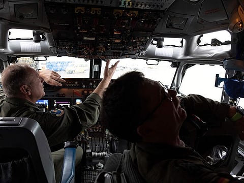 Pilots work in the cockpit of an AWACS plane at Melsbroek military airport in Melsbroek, Belgium, Wednesday, Nov. 27, 2019.