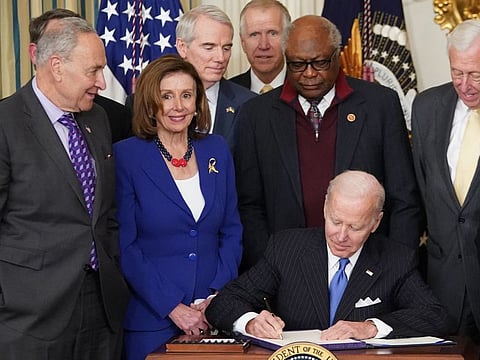 An April 5, 2022 photo shows US President Joe Biden signing H.R. 3076, the Postal Service Reform Act of 2022, during a ceremony in the State Dining Room of the White House in Washington, DC. From left: Senate Majority Leader Chuck Schumer, House Speaker Nancy Pelosi, Senator Rob Portman, Senator Thom Tillis, and House Majority Whip Jim Clyburn, and Senate Majority Leader Steny Hoyer. Nancy Pelosi, the Democratic speaker of the US House of Representatives, has tested positive for Covid-19, her spokesman said April 7, 2022.