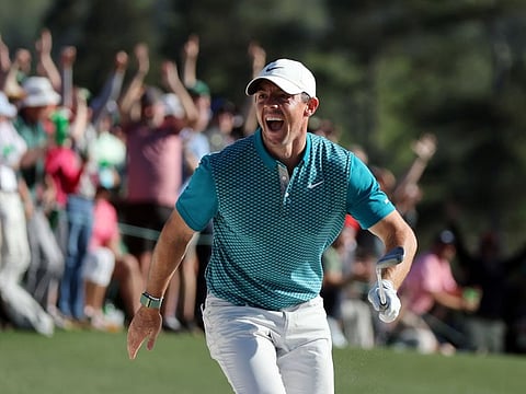 Rory McIlroy of Northern Ireland reacts after chipping in for birdie from the bunker on the 18th green during the final round of the Masters at Augusta National Golf Club in Augusta, Georgia.