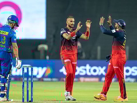 Harshal Patel of Royal Challengers Bangalore celebrates the wicket of Ramandeep Singh of Mumbai Indians at the MCA International Stadium in Pune on Saturday.