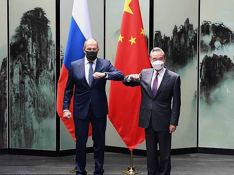 Chinese Foreign Minister Wang Yi poses for photos with Russian Foreign Minister Sergei Lavrov in Tunxi, eastern China's Anhui Province, Wednesday, March 30, 2022.