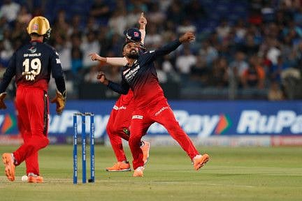 Royal Challengers Bangalore's Wanindu Hasaranga celebrates the dismissal of Mumbai Indians' Dewald Brevis during the TATA IPL 2022 match at MCA Stadium in Pune on Saturday.