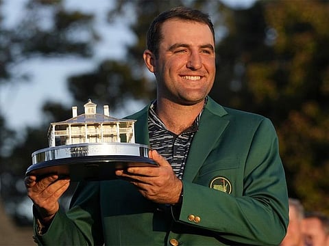 Scottie Scheffler holds the championship trophy after winning the 86th Masters golf tournament on Sunday, April 10, 2022, in Augusta.