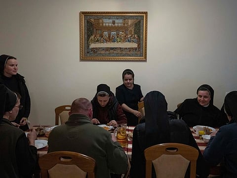 Nuns eat dinner, at the Hoshiv Women Monastery, where they have been taking in internally displaced families fleeing the war, in Ivano-Frankivsk region, western Ukraine. Before the war, the nuns led a tranquil life. In addition to their religious duties and charitable work, they grew mushrooms, made their own pasta and painted icons. Now, they run after young children, provide support to their mothers and cook daily for dozens of guests. 