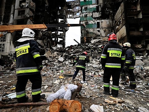 Rescuers search for bodies under the rubble of a building destroyed by Russian shelling  in Borodyanka, Kyiv region, on April 11, 2022.  