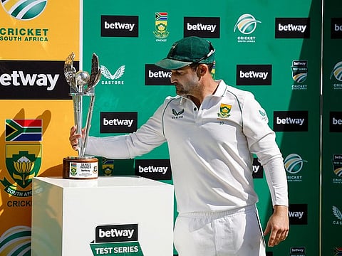 South Africa's Test captain Dean Elgar picks up the winners' trophy after they won the series 2-0 against Bangladesh. 