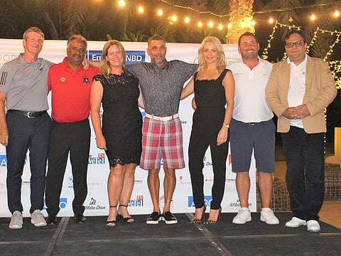 Russell Yeomans (left) of Sport2Business alongwith winners and sponsors of the first leg of Emirates NBD Race to Malaysia Qualifier at Montgomerie Golf Club.
