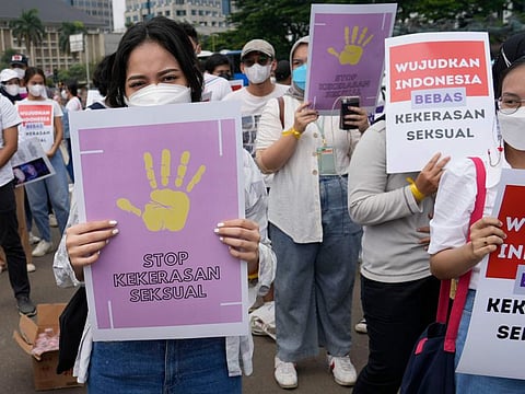 Activists hold posters that read “Stop sexual violence” and “Free Indonesia from sexual violence”, during a rally commemorating the International Women’s Day in Jakarta, on March 8, 2022.  