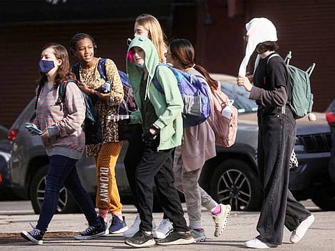 Children are seen walking to school, on the first day of lifting the indoor mask mandate for DOE schools between K through 12, in Brooklyn, New York City, on March 7, 2022. 