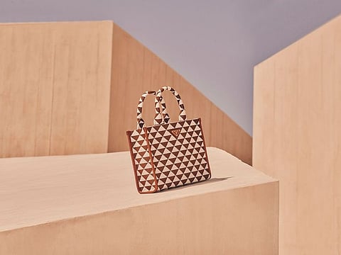 The exclusive collection features iconic Prada bags.