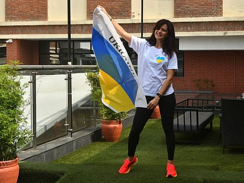 Ukraine's mountaineer Antonina Samoilova with Ukraine's national flag before an interview with AFP in Kathmandu. 