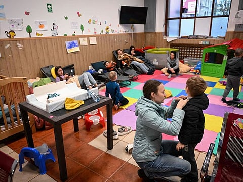 Ukrainian refugee children and mothers are pictured inside one of the resting rooms made to accomodate refugee from Ukraine at "The North Railway Station" in Bucharest April 12, 2022.