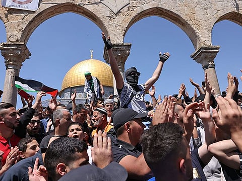 Palestinian Muslim worshippers protest following Friday prayers at Jerusalem's Al Aqsa Mosque complex, on April 15, 2022.