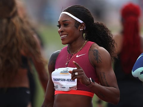 Elaine Thompson-Herah of Jamaica poses for a photo at the finish of the women's 100 meter dash semi-finals during the Mt SAC Relays Elite Division & USATF Golden Games at Hilmer Lodge Stadium in Walnut, California.