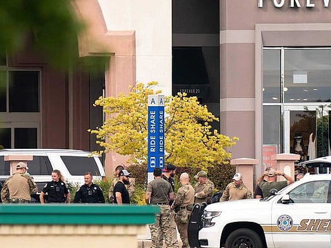 Members of law enforcement gather outside Columbiana Centre mall in Columbia, S.C., following a shooting, April 16, 2022. Authorities in South Carolina say they are investigating shooting at a club in Hampton County early Sunday, April 17, 2022 that left at least nine people injured. It was the second mass shooting in the state in as many days.