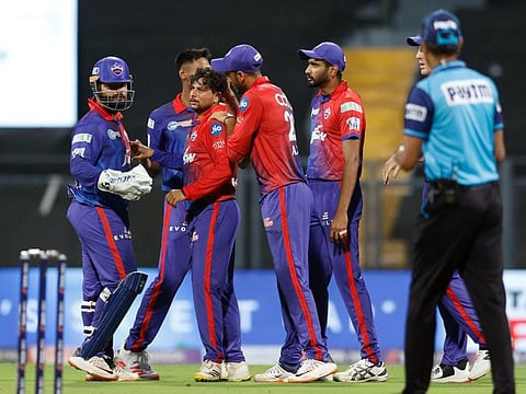 Delhi Capitals' Kuldeep Yadav celebrates the wicket of Royal Challengers Bangalore's Glenn Maxwell at Wankhede Stadium in Mumbai on Saturday. The team members are in quarantine after one of the players tested positive.