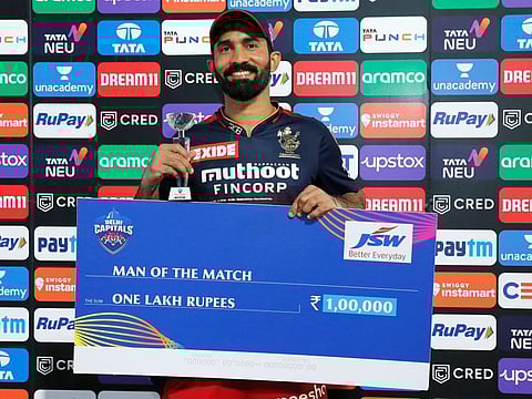 Dinesh Karthik of Royal Challengers Bangalore receives the Man of the match award during the presentation of the match 27 of the TATA Indian Premier League 2022 (IPL season 15) after beating Delhi Capitals at the Wankhede stadium in Mumbai.