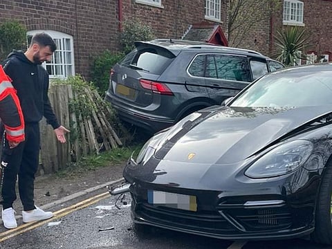 Bruno Fernandes inspects the damage after the crash which took place just a few miles from Manchester United's training base.