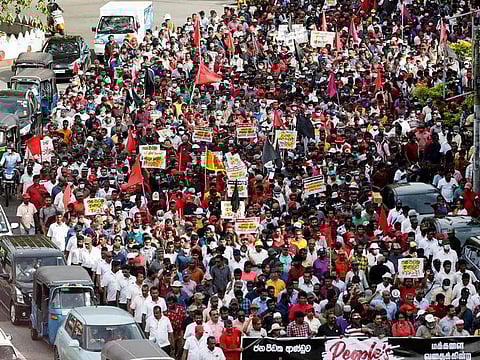 Members and supporters of Sri Lanka's opposition the National People's Power Party march towards Colombo from Beruwala, during a protest against President Gotabaya Rajapaksa, amid the country's economic crisis, on April 19, 2022. 